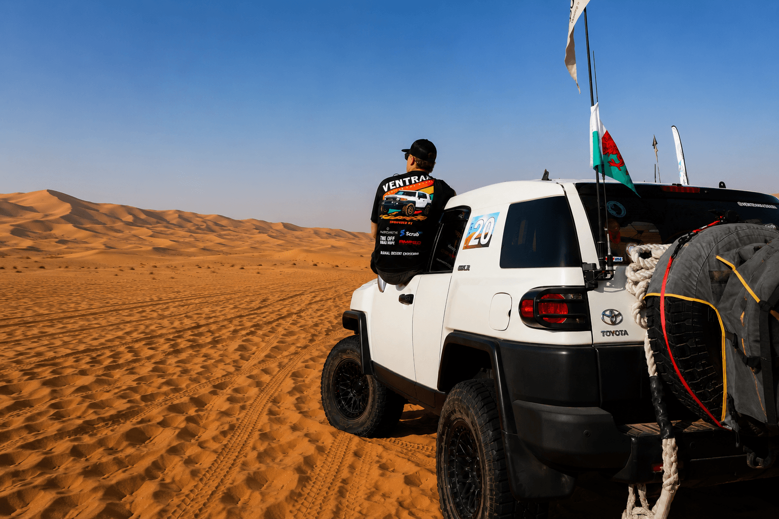 Declan Jones of Ventrax Offroad beside a Toyota FJ Cruiser in the UAE desert