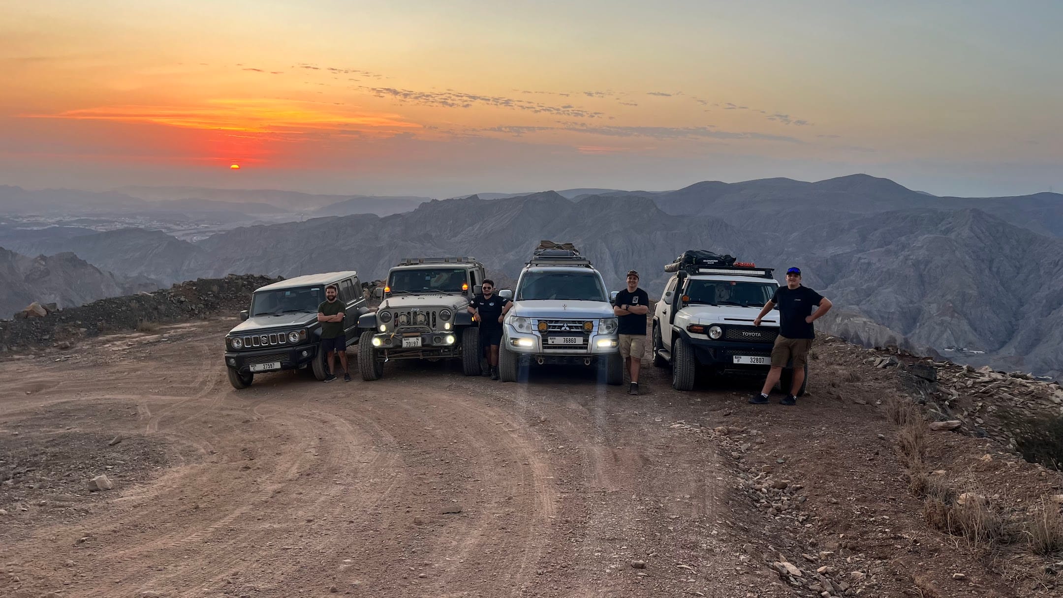 Ventrax Offroad crew with four 4x4 vehicles in the Hatta mountains at sunset